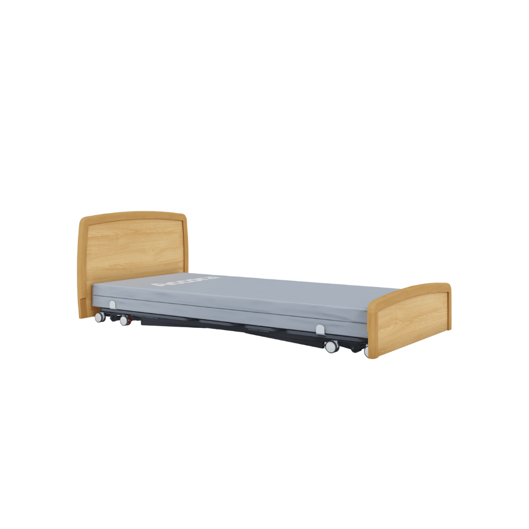 The Accora Contesa® FloorBed® Hi/Low Full Electric Bed features a low wooden frame with light wood headboard and footboard, a grey mattress, and wheels—ideal for fall prevention and safer patient care.