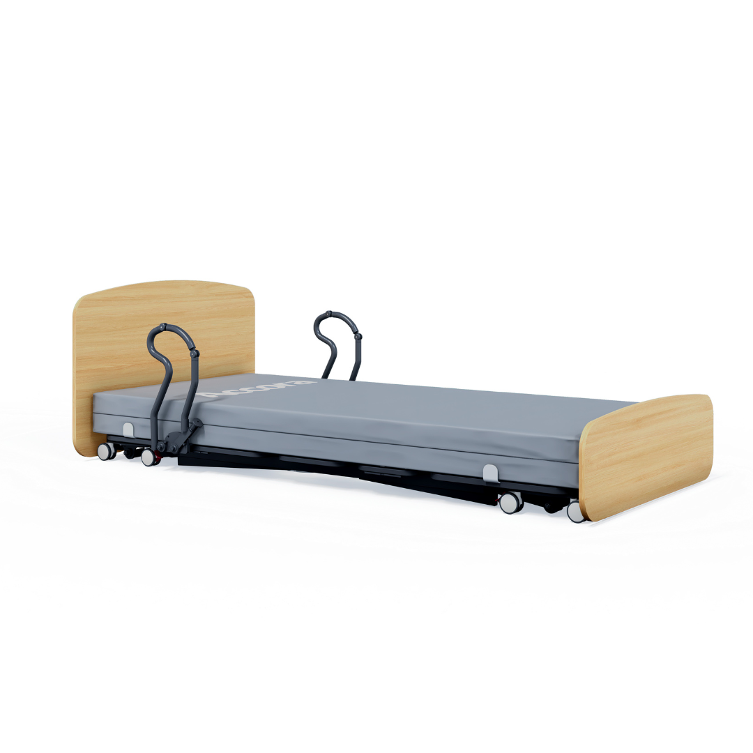 The Accora Contesa® FloorBed® Hi/Low Full Electric Bed has a gray mattress, wooden head/footboards, safety rails, and wheels for mobility. Its low height helps prevent falls by keeping the bed close to the floor.