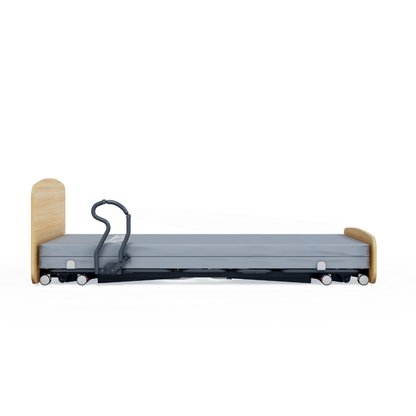 The Accora Contesa® FloorBed® Hi/Low Full Electric Bed is a modern, low-profile hospital bed for fall prevention, with a wooden headboard and footboard, gray mattress, and one black safety rail, shown from the side on a white background.