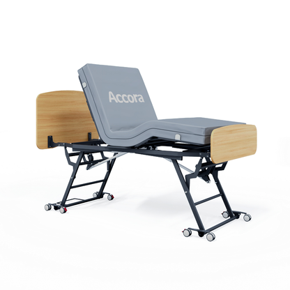 The Accora Contesa® FloorBed® Hi/Low Full Electric Bed features gray cushioning, a black metal frame, light wood head and foot panels, and wheels—a stylish fall-prevention solution identified by the Accora label against a white background.