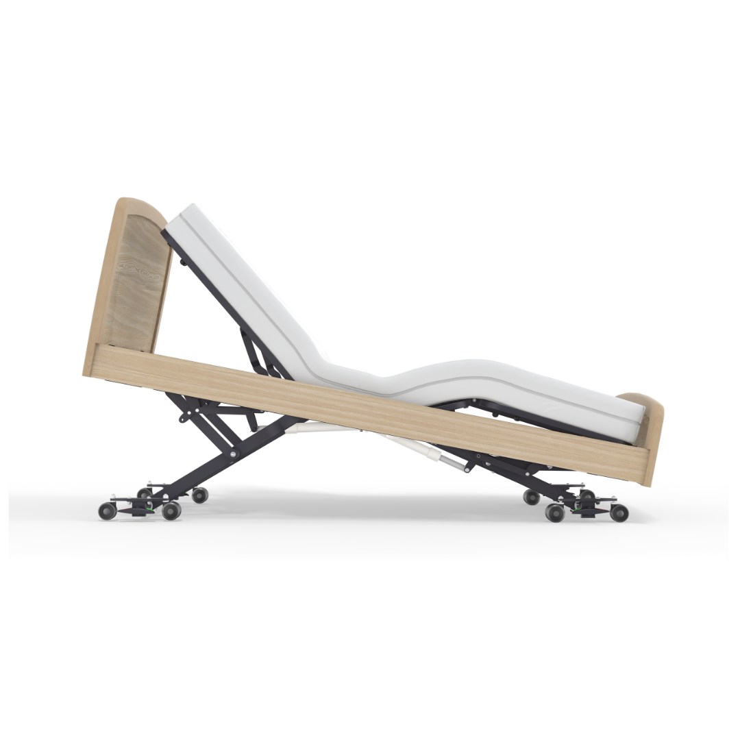 The Accora Empresa® Full Electric Bariatric FloorBed® features a modern wooden frame and white mattress, shown reclined with head and legs elevated on a wheeled metal base.