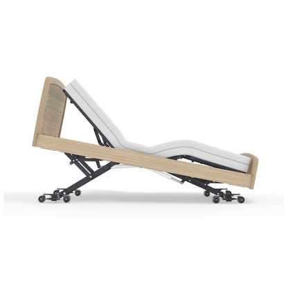 The Accora Empresa® Full Electric Bariatric FloorBed® features a modern wooden frame and white mattress, shown reclined with head and legs elevated on a wheeled metal base.