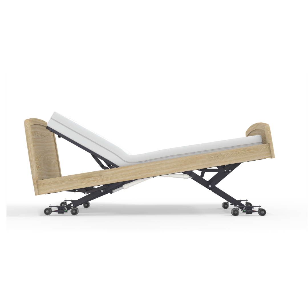 The Accora Empresa® Full Electric Bariatric FloorBed® is pictured partially elevated, featuring a black metal frame on wheels, light wood headboard and footboard, and a comfortable white mattress.