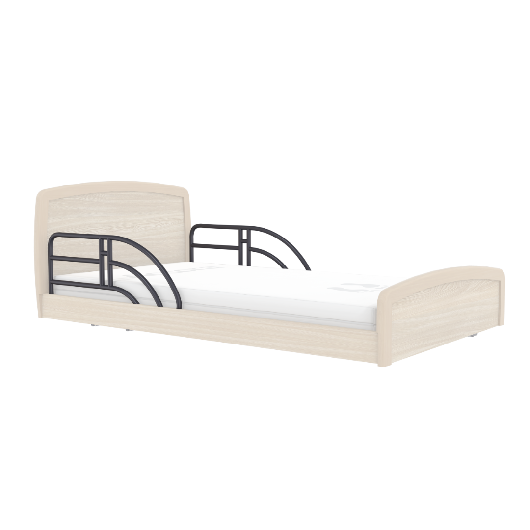 The Accora Empresa® Full Electric Bariatric FloorBed® is a light wood single bed with a white mattress, black metal safety rails on both sides, and curved headboard and footboard for style and security.