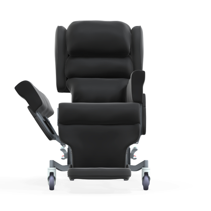 Front view of the Accora Configura® Advance Postural Tilt Chair, a black reclining chair with padded seat, armrests, extended leg rest, and four wheels, shown isolated on a white background.