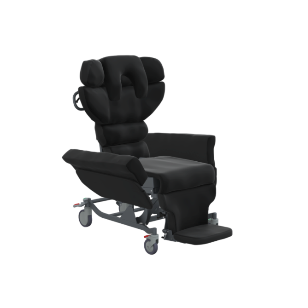 The Accora Configura® Advance Postural Tilt Chair in black, featuring padding, armrests, a headrest, adjustable leg support, and wheels for mobility is shown against a plain white background.