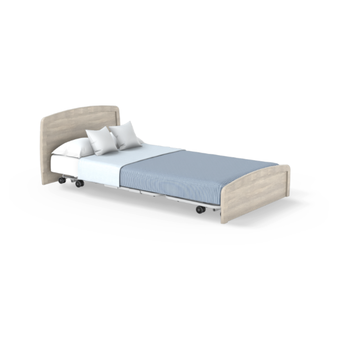 The Accora Empresa® Full Electric Bariatric FloorBed® features a light wood headboard and footboard, light blue bedding, and two white pillows. It stands on wheels against a white background; product details are shown with no CSS styling code.