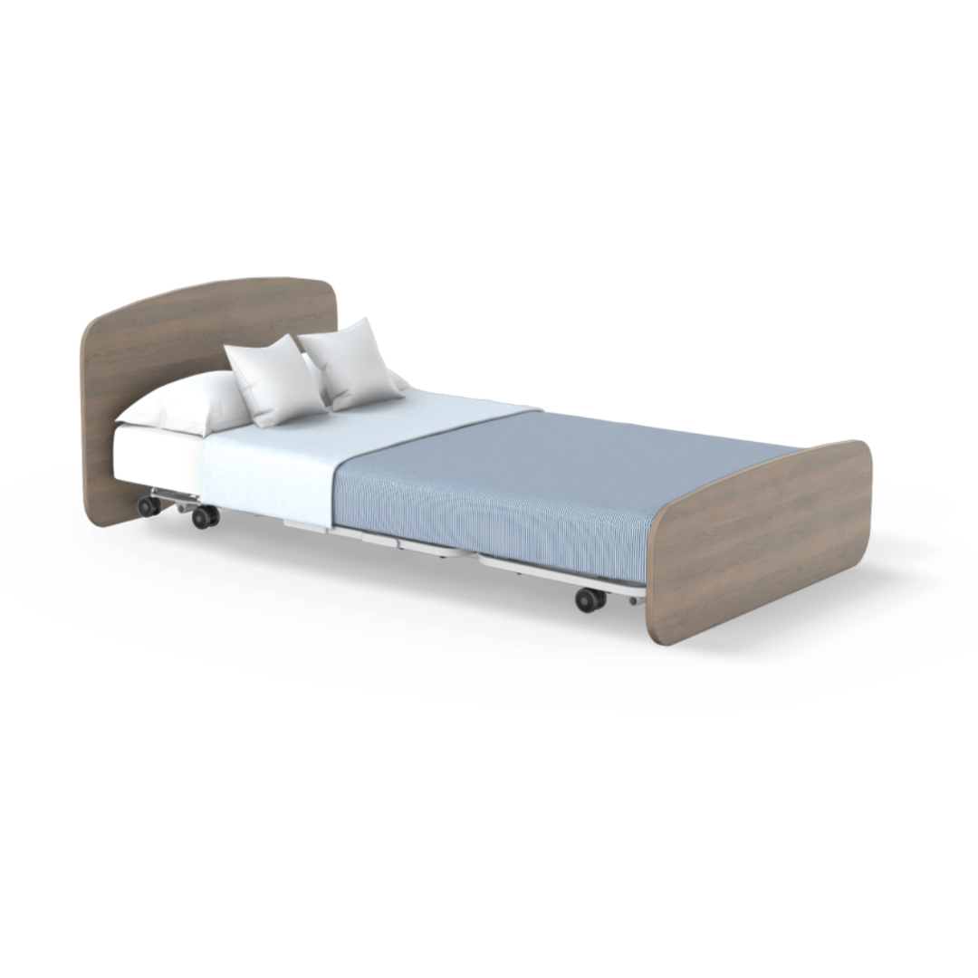 The Accora Empresa® Full Electric Bariatric FloorBed® features a sturdy wooden headboard and footboard, light blue bedding, white pillows for comfort, and smooth-rolling wheels, all set against a crisp white background.