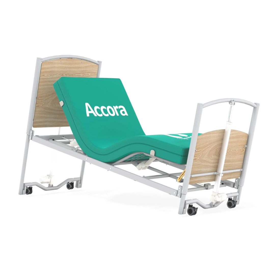 The Accora FloorBed® Ultra Low Full Electric Homecare Bed features a green mattress, adjustable head and knee sections, a sturdy metal frame, wooden end panels, and wheels for easy movement.