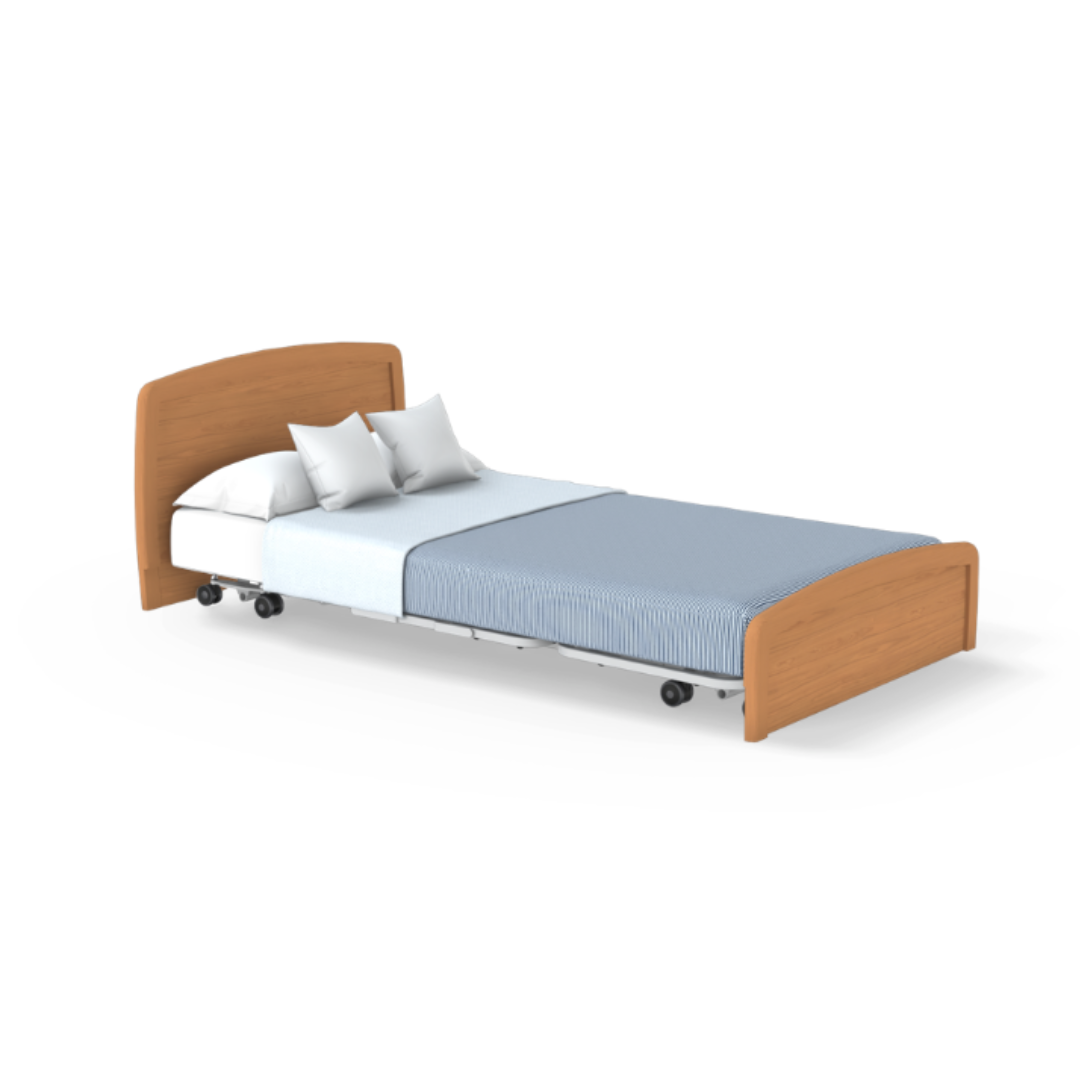 The Accora Empresa® Full Electric Bariatric FloorBed® features a light wood headboard and footboard, blue and white bedding, two pillows, and wheels—displayed on a clean white background, perfect for modern healthcare settings.