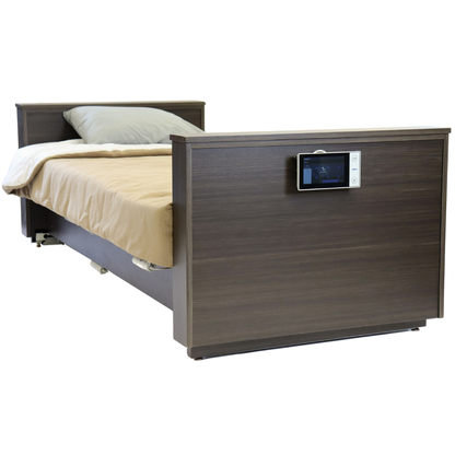 The Med-Mizer ActiveCare Rotating Hospital Bed features a brown wooden frame, beige bedding, a gray pillow, and an electronic control panel on the footboard.
