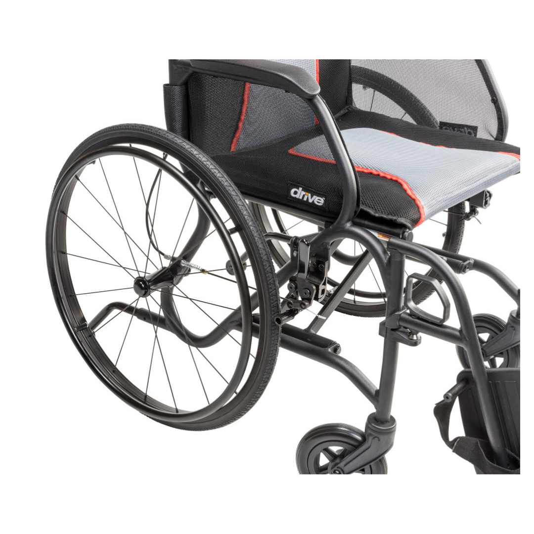 A close-up of the Drive AeroFly™ Ultra-Lite Wheelchair with Companion Brakes, highlighting its black and red mesh seat, large rear wheel, and part of the magnesium alloy frame.