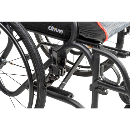 Close-up of the Drive AeroFly™ Ultra-Lite Wheelchair with Companion Brakes in black, highlighting its lightweight frame, wheel, locking mechanism, and the Drive logo on the seat upholstery.