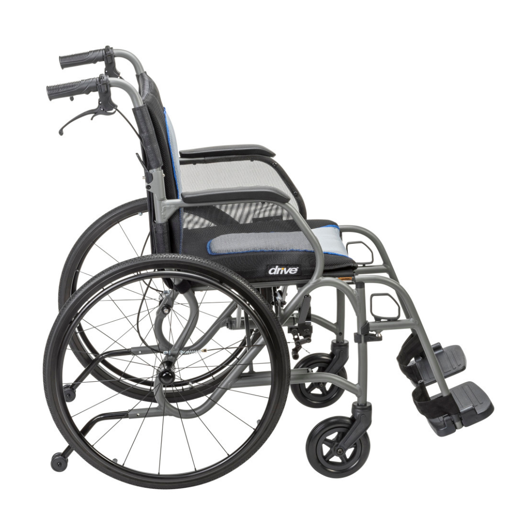 The Drive AeroFly™ Ultra-Lite Wheelchair with Companion Brakes features large rear wheels, small front casters, footrests, a silver frame with black and blue accents, plus a mesh seat—ideal as a travel wheelchair for easy portability.