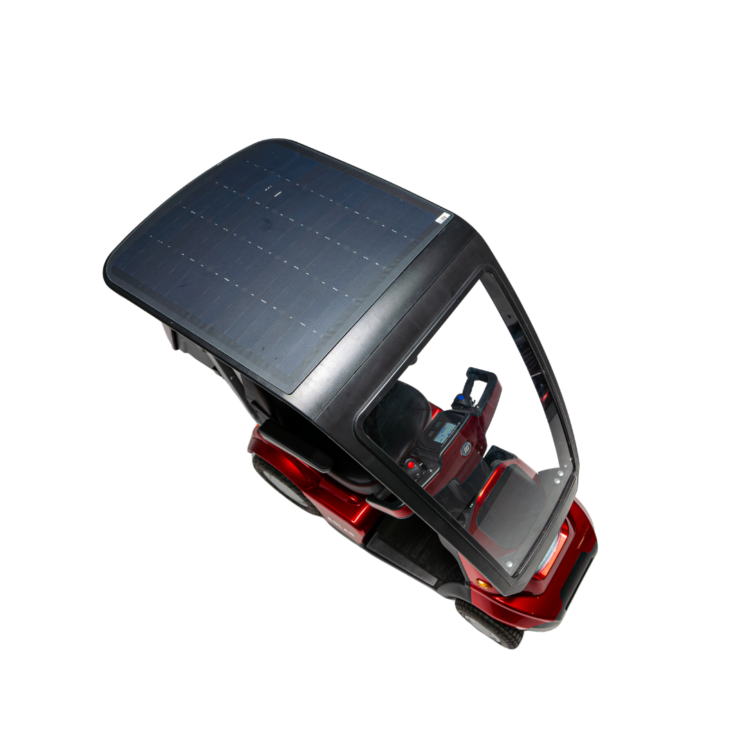 A top view of the Afikim Afiscooter Solar, a small red mobility scooter with a large transparent solar panel canopy on a white background, reveals the interior emphasizing solar charging efficiency for sustainable energy. The wheels are at the corners for stability.