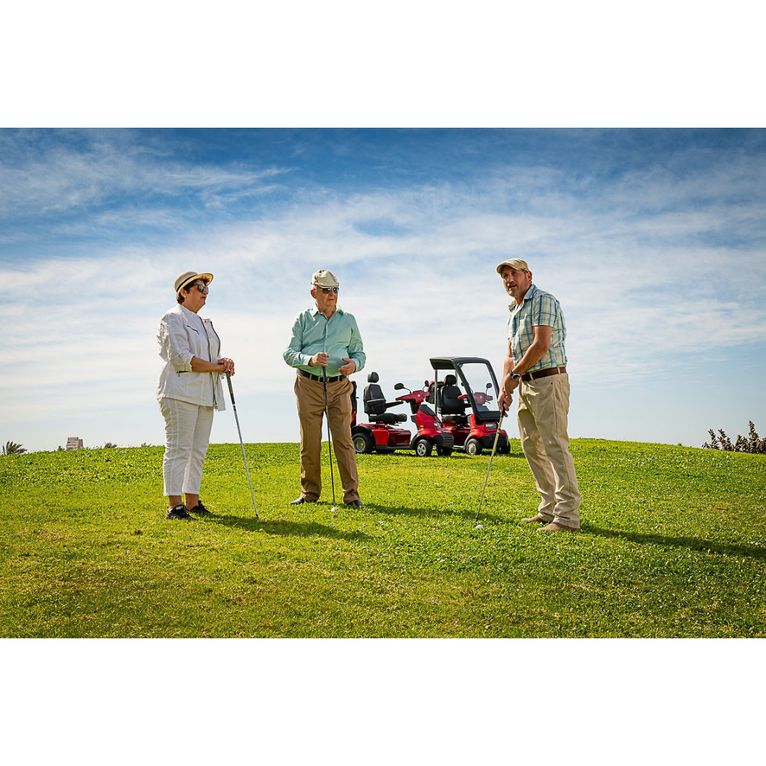 Three people in casual golf attire stand on a grassy hill with clubs. An Afikim Afiscooter Solar, recognized for its solar charging efficiency, is parked nearby, against a backdrop of blue sky and scattered clouds, emphasizing their commitment to sustainable energy on the course.