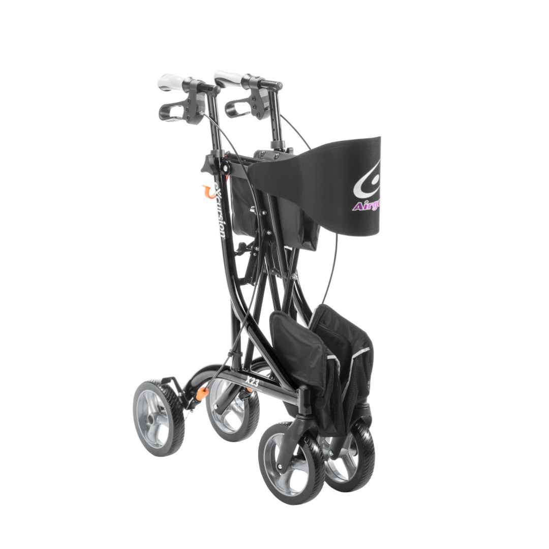 The Drive Airgo eXcursion X23 Lightweight Rollator for tall users is a foldable black rollator with four wheels, hand brakes, and a front storage bag, shown upright for compact transport or storage.