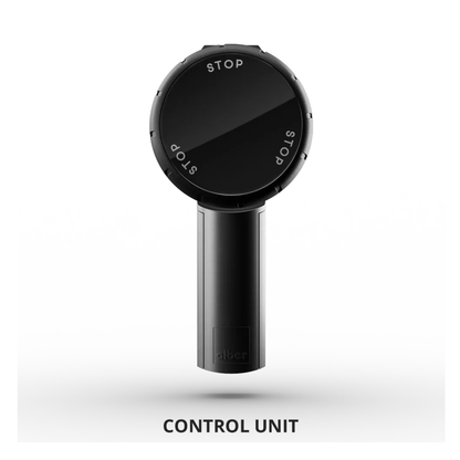A black, circular control unit with a handle and “STOP” written three times around the dial, designed for use with the Alber SMOOV One Power Assist, sits on a white background labeled "CONTROL UNIT.