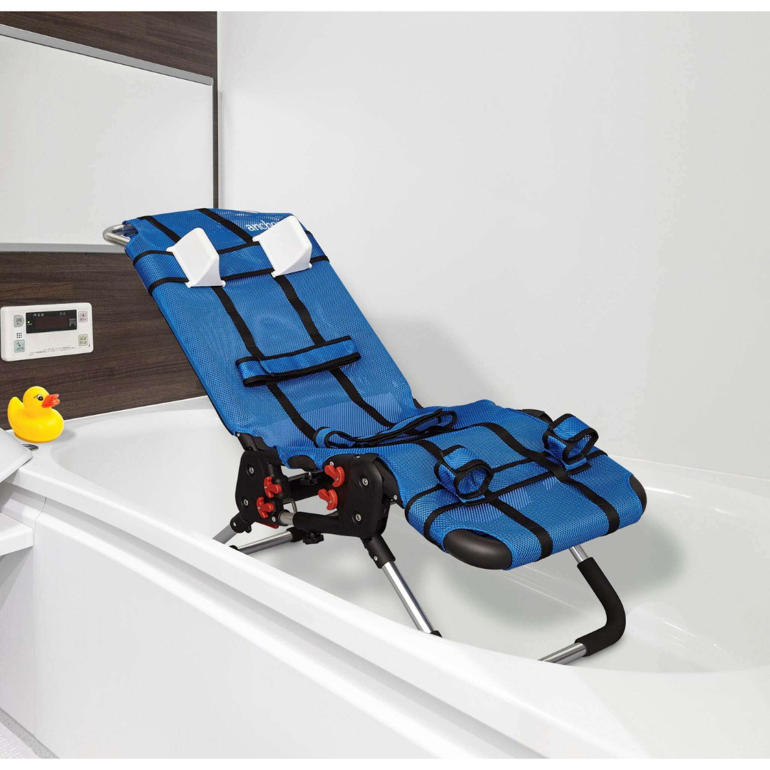 The Circle Specialty Pediatric Anchor Bath Chair in blue, with black straps and a headrest, is set in a white bathtub. A yellow rubber duck rests on the tub's edge, and a digital control panel is mounted on the wall nearby.