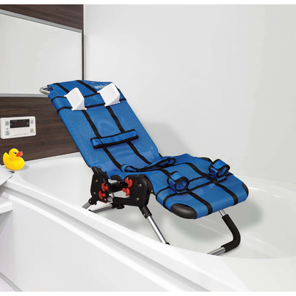The Circle Specialty Pediatric Anchor Bath Chair in blue, with black straps and a headrest, is set in a white bathtub. A yellow rubber duck rests on the tub's edge, and a digital control panel is mounted on the wall nearby.