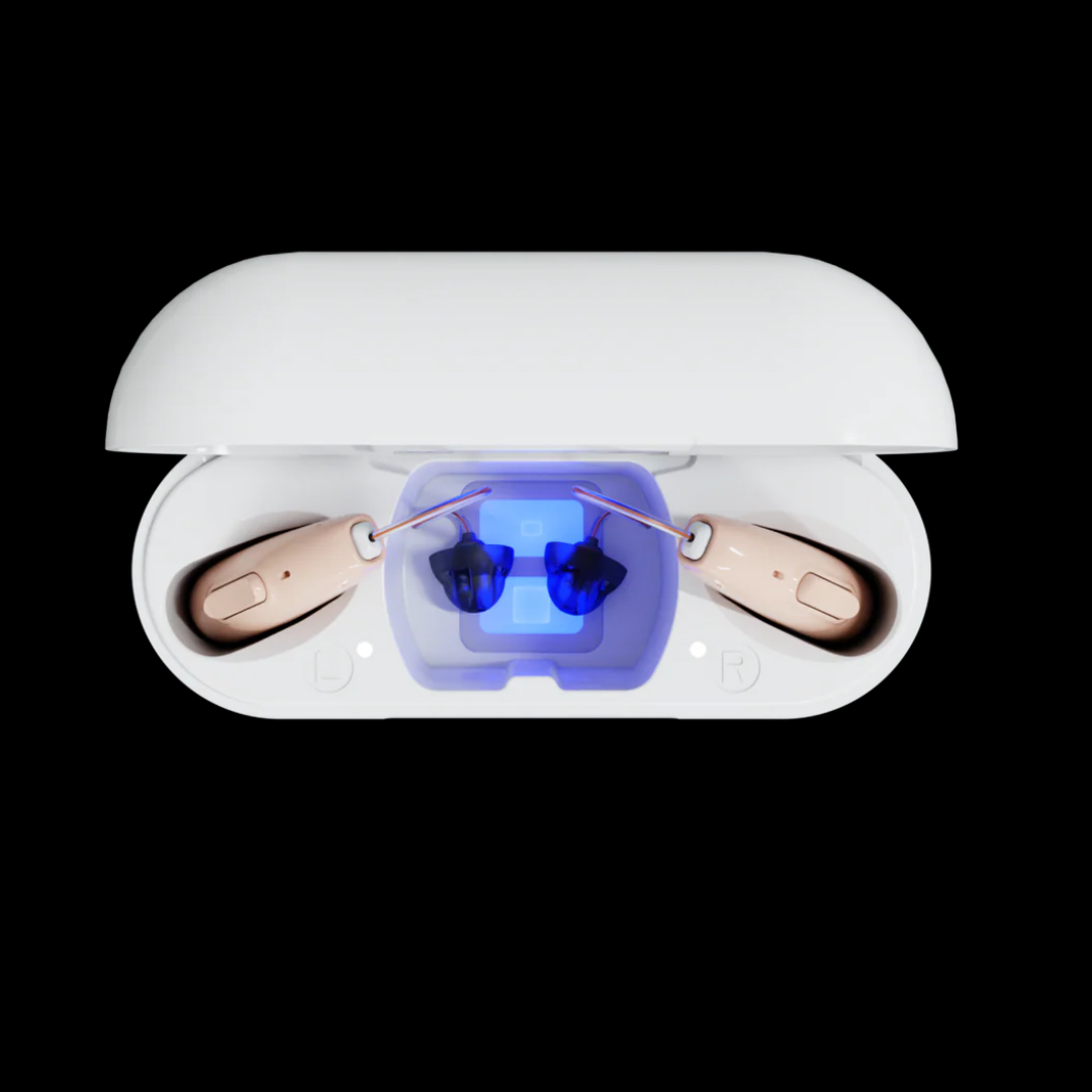 A pair of Audien Hearing ION Pro 2 Over-The-Ear High Def beige hearing aids with personalized profiles rest in an open white charging case glowing blue at the center, set against a black background.