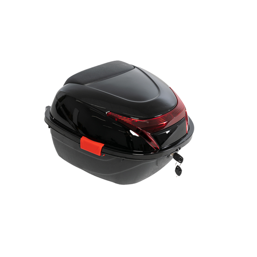 A Pride Mobility Scooter Storage Pod in black with a red reflector, gray padded top, and orange side latch. A key is inserted in the front key-locking design. The background is white.