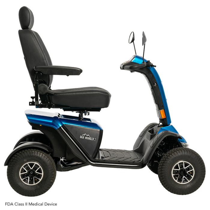 The Pride Baja® Wrangler® 2 Heavy Duty Outdoor Scooter, in blue, features a black seat, four wheels, rearview mirrors, and sturdy tires for rugged terrain. It ensures comfort and support for mobility needs and has visible FDA Class II medical device labeling.