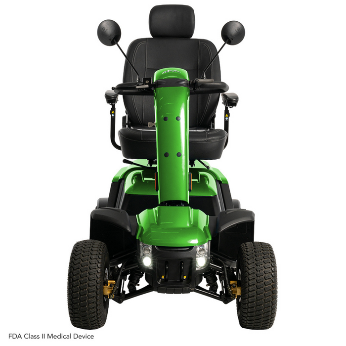 The Pride Baja® Wrangler® 2 is a green outdoor mobility scooter with a cushioned seat, handlebars, and two rearview mirrors. Designed for rugged terrain, it features large wheels, headlights, and CTS Suspension for a smooth ride. Labeled as an FDA Class II Medical Device.