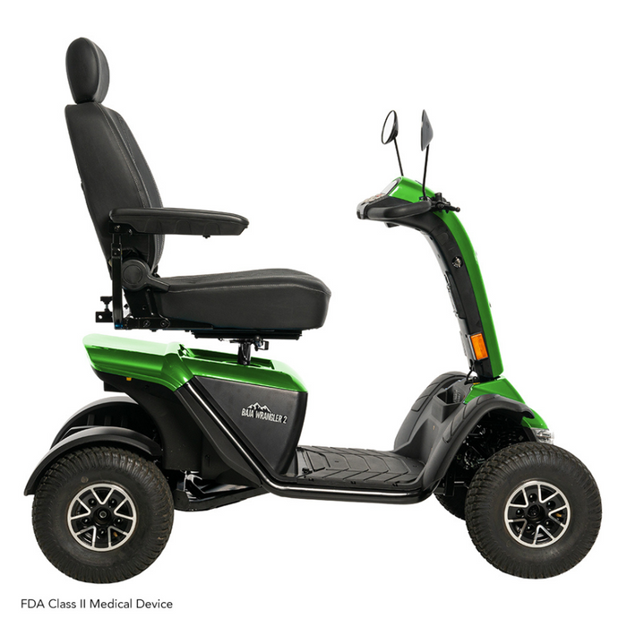 The Pride Baja® Wrangler® 2 Heavy Duty Outdoor Scooter in green and black features four rugged wheels, a cushioned seat with armrests, and handlebars with mirrors. Known for its durability and performance, its classified as an FDA Class II Medical Device.
