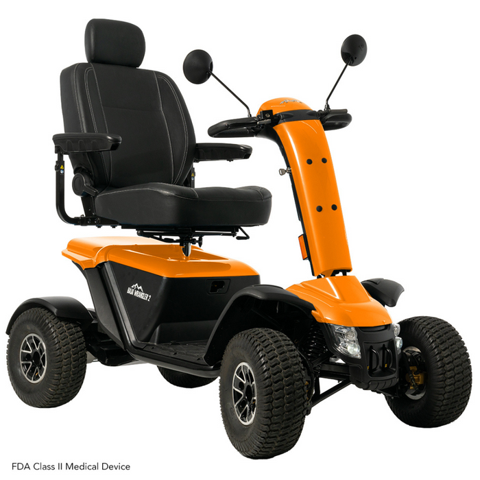 The Pride Baja® Wrangler® 2 Heavy Duty Outdoor Scooter is a rugged, four-wheel orange and black mobility scooter with a padded seat and armrests, large durable tires for rough terrain, handlebars with mirrors, and is an FDA Class II medical device.