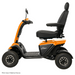 Side view of the Pride Baja® Wrangler® 2 Heavy Duty Outdoor Scooter in orange and black, featuring a padded seat with armrests, backrest, and four large wheels for tough terrain. Image text: FDA Class II Medical Device.