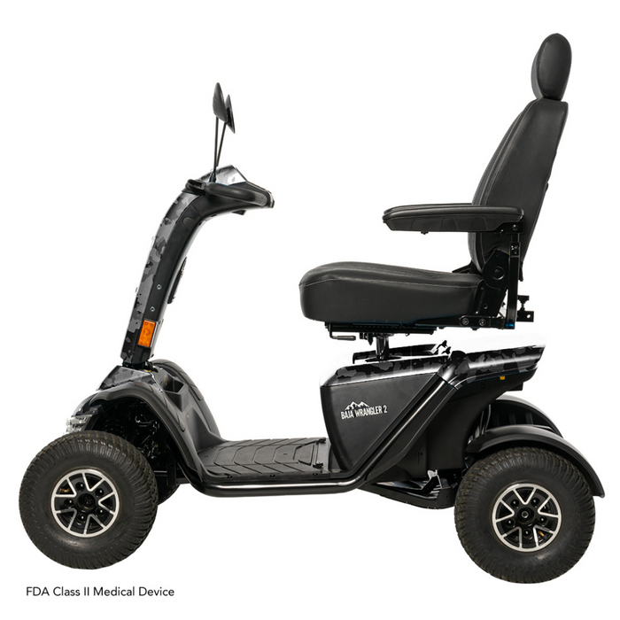 Side view of the Pride Baja® Wrangler® 2, a black outdoor scooter designed for rugged terrain. It features an elevated seat, armrests, backrest, four large wheels, and a handlebar for smooth outdoor travel with durability and top performance in mind.