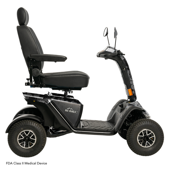 The Pride Baja® Wrangler® 2 is a black outdoor mobility scooter with four rugged wheels, ideal for tough terrain. It features a high-back seat, handlebar rearview mirrors, CTS Suspension, and front reflectors for visibility. Its an FDA Class II Medical Device.