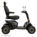 The Pride Baja® Wrangler® 2 is a black outdoor mobility scooter with four rugged wheels, ideal for tough terrain. It features a high-back seat, handlebar rearview mirrors, CTS Suspension, and front reflectors for visibility. Its an FDA Class II Medical Device.