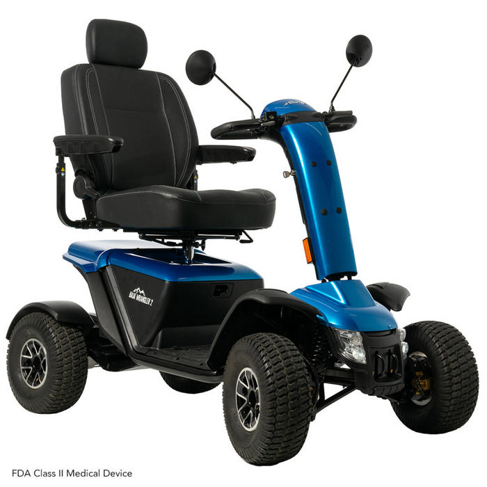 The Pride Baja® Wrangler® 2 is a blue outdoor scooter with four wheels, a black cushioned seat, modern design, rugged tires, mirrors, and an easy-to-use control panel with handles for seamless navigation in personal transportation.