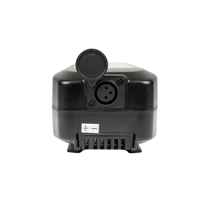 The Battery for Forcemech Carbon F1 Power Chair is a lightweight black electronic device with a hinged cap over a circular port, three-pin connector, and metal terminals labeled positive and negative—perfect for power chairs.