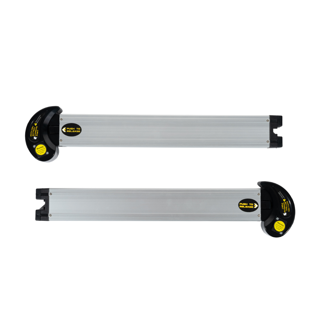 Two silver rectangular roof rack cross bars with black end caps and yellow labels, set parallel on a white background—perfect for trips where FAA approved gear like the Forcemech Forcemax® Battery for Navigator Powerchair is needed.