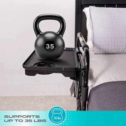 A 35-pound kettlebell rests on the Stander Bed Rail Tray Accessory attached to a bed rail, showing its ability to support up to 35 lbs. Text at the bottom reads: Supports up to 35 lbs.