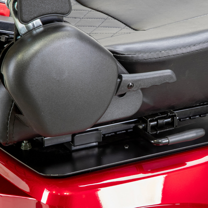 Close-up of a black armrest adjustment lever on the side of a diamond-stitched padded seat, mounted on a shiny red Bespoke Legacy Recreational 3-Wheel Scooter with a powerful 600-watt motor.