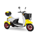 The Bespoke Supreme Euro-Style Recreational 3-Wheel Scooter with Electric Brake Assist features a white and yellow body, black seat, front basket, rear storage box, and striking red-rimmed wheels, shown from a front-side angle.