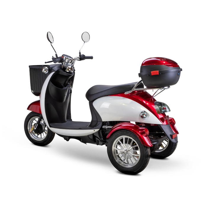 The Bespoke Supreme Euro-Style Recreational 3-Wheel Scooter with Electric Brake Assist, in red and white, has a 600-watt motor, a black front basket, rear storage box, two mirrors, silver rims, shown from the back left on a white background.