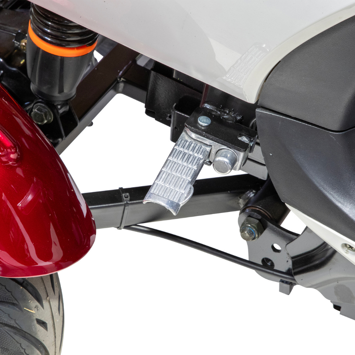 Close-up of the Bespoke Supreme Euro-Style Recreational 3-Wheel Scooter with Electric Brake Assist, showing its silver foot peg, red fender, black suspension with orange accent, and part of the wheel—all set against a white background.