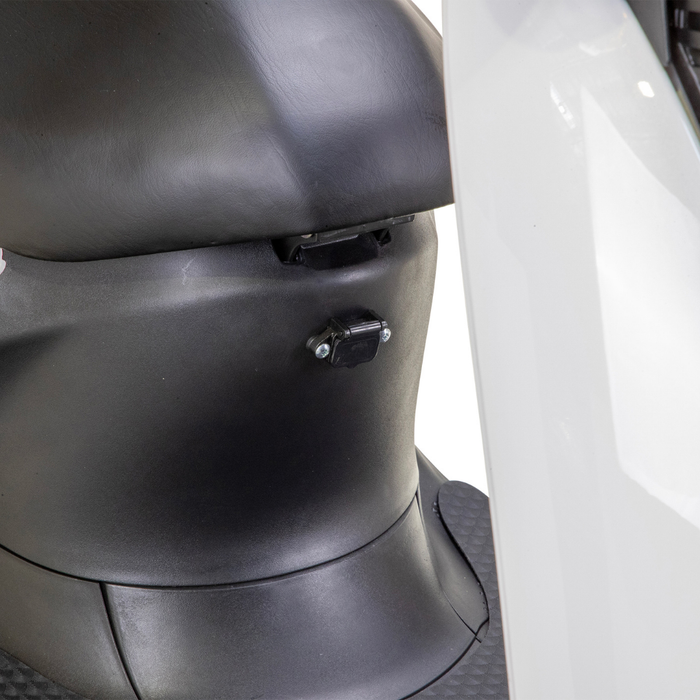 Close-up of the under-seat area on the black and white Bespoke Supreme Euro-Style Recreational 3-Wheel Scooter with Electric Brake Assist, featuring its locking mechanism, part of the footrest, and advanced technology details.