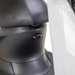 Close-up of the under-seat area on the black and white Bespoke Supreme Euro-Style Recreational 3-Wheel Scooter with Electric Brake Assist, featuring its locking mechanism, part of the footrest, and advanced technology details.