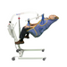 A person reclines in the Bestcare General Purpose Clip Sling with padded legs, fitted to a white portable lift that has an integrated head support and utilizes a hydraulic arm. Padded leg supports and wheels finish the lift; the individual wears black pants and brown shoes.