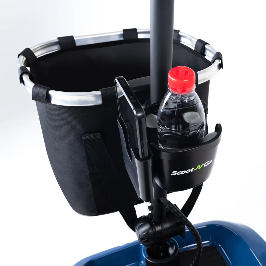 Close-up of a mobility scooter’s handlebar area, showcasing a black basket, the Bottle & Phone Holder Combo for ScootNgo Scooters, and a cup holder with a plastic water bottle inside. The “Scoot N Go” logo is visible on the holder, highlighting the practicality of ScootNgo scooter accessories.