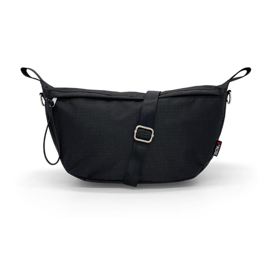 The ByAcre Accessories for Overland Carbon Fiber Rollators include a sleek black crossbody bag with a minimalist design, silver buckle, adjustable strap, rectangular shape, side loops, and a subtle logo tag—perfect for those seeking elegant style in a must-have accessory.