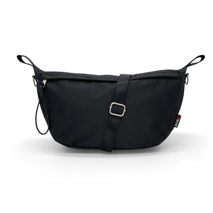 The ByAcre Accessories for Overland Carbon Fiber Rollators include a sleek black crossbody bag with a minimalist design, silver buckle, adjustable strap, rectangular shape, side loops, and a subtle logo tag—perfect for those seeking elegant style in a must-have accessory.