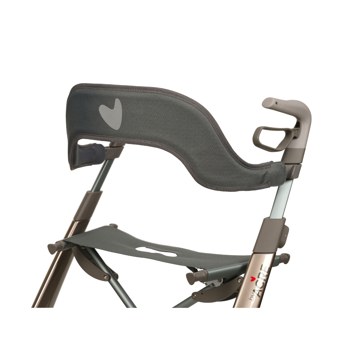 A close-up of the Backrest For byAcre Overland Carbon Fiber Rollators shows the mesh backrest and seat with heart-shaped cutouts, paired with a metallic frame, ergonomic handles, and a modern design.
