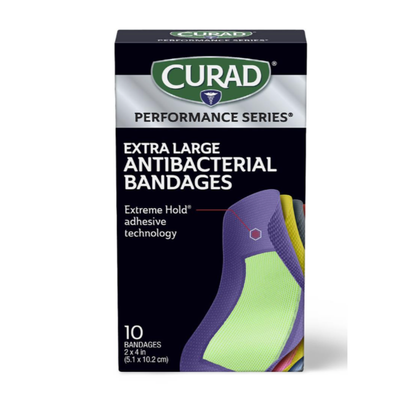 A box of Medline CURAD Performance Series Antibacterial Bandages, Extra Large, Extreme Hold adhesive. Contains 10 bandages, each 2 x 4 inches. The colorful front shows overlapping bandages.